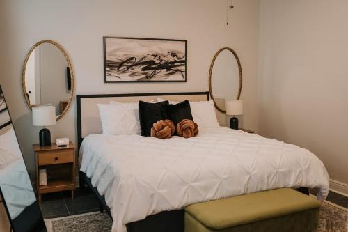 a bedroom with a large bed with two large mirrors at Long Term Stay Fast Wifi Comfortable in Lake Charles