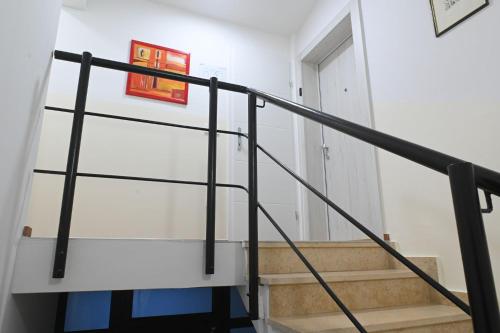 a staircase in a house with a red picture on the wall at AdisiTi S1 in Zagreb