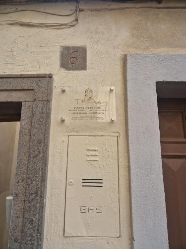 a building with a sign on the side of it at Piazza Duomo casa vacanze in Sutri