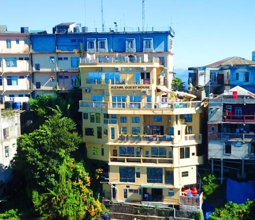 a tall building with blue and white at Aizawl Guest House in Āīzawl