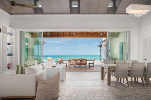 a living room with a view of the ocean at Ambergris Cay - Private Island All-Inclusive in Big Ambergris Cay