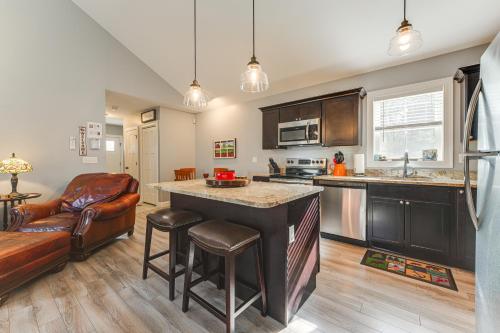 a kitchen with a bar and a couch in a room at Ski, Hike and Boat Modern Bridgton Retreat in Bridgton