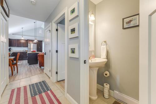 a bathroom with a sink and a toilet and a kitchen at Ski, Hike and Boat Modern Bridgton Retreat in Bridgton
