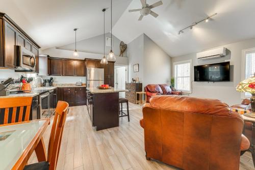 a kitchen and living room with a brown leather couch at Ski, Hike and Boat Modern Bridgton Retreat in Bridgton