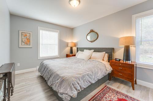 a bedroom with a bed and a table with a mirror at Ski, Hike and Boat Modern Bridgton Retreat in Bridgton