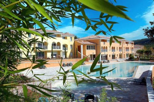 a resort with a swimming pool and a building at Two rooms appartment in residence with pool in Gréoux-les-Bains