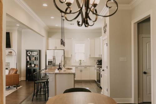 a kitchen with a table and chairs and a chandelier at Long Term Stay Fast Wifi Comfortable in Lake Charles