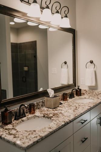 a bathroom with two sinks and a large mirror at Long Term Stay Fast Wifi Comfortable in Lake Charles