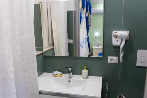 a bathroom with a sink and a mirror at La Dolce Casa in Rome