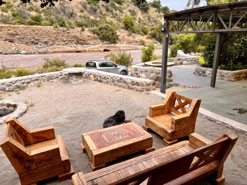 a dog sitting on a table and two benches at Altos de Guayacan in San José de Maipo