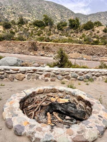 a stone fire pit in the middle of a field at Altos de Guayacan in San José de Maipo