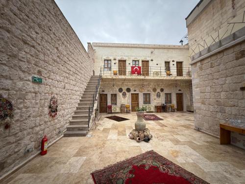 a large building with a staircase in the middle of a courtyard at Timur inn Cappadocia in Goreme