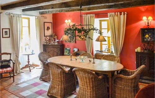 a dining room with a wooden table and wicker chairs at Awesome Home In Montaut With Wifi in Montaut