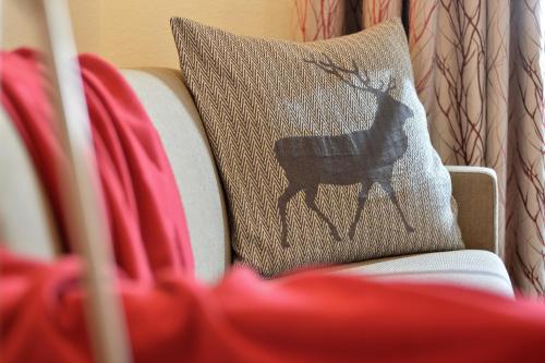 a pillow with a picture of a dog on a couch at Wohlfühlhotel Schiestl in Fügen
