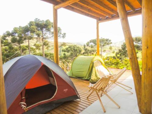a tent and a chair on a porch at Cabana Mendoza - Busch Camping in Rancho Queimado