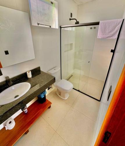 a bathroom with a toilet and a sink and a shower at Cabana Mendoza - Busch Camping in Rancho Queimado