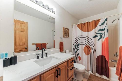 a bathroom with a sink and a toilet and a mirror at Easton Hills in Spicer