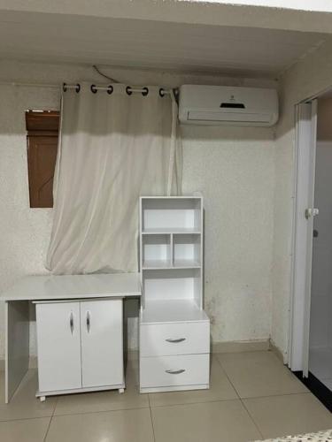 a room with a white desk and a heater at Casa maravilhosa in Natal