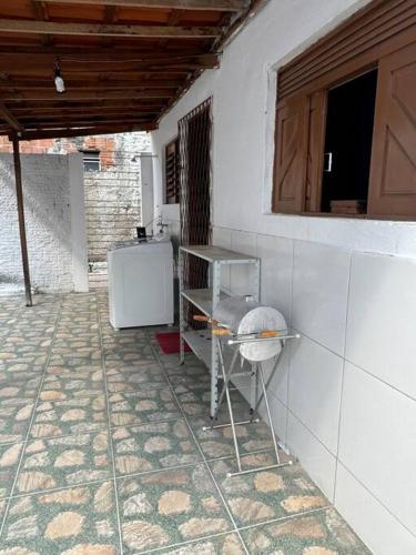 a kitchen with a counter and a refrigerator in a room at Casa maravilhosa in Natal