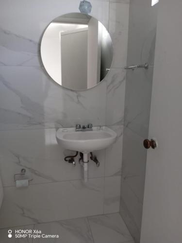 a bathroom with a sink and a mirror at Estancia Monraz in Guadalajara