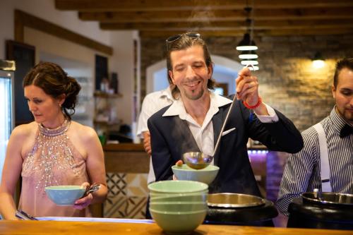 a man and a woman standing in a kitchen at Resort Mlýn Karolínka in Vranov nad Dyjí