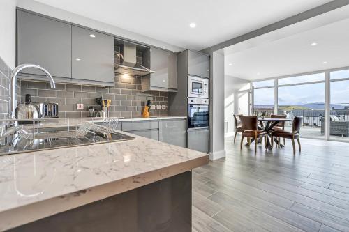 a kitchen with a counter and a dining room at BayView Luxury 2 Bedroom Apartment Ground Floor in Downings