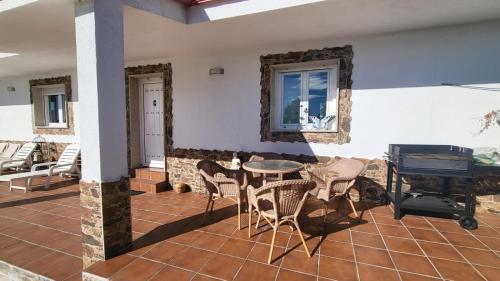 a patio with a table and chairs and a piano at “Casa abella “ in La Magdalena