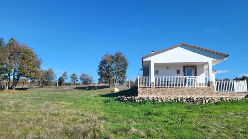 a small house in a field with a blue sky at “Casa abella “ in La Magdalena