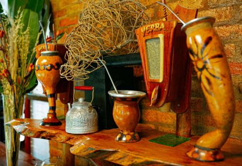a table with several vases on top of it at La Aldea De La Selva Lodge in Puerto Iguazú