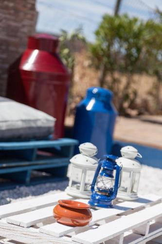 a table topped with candles and bottles on a table at Monte Farropo in Monsaraz