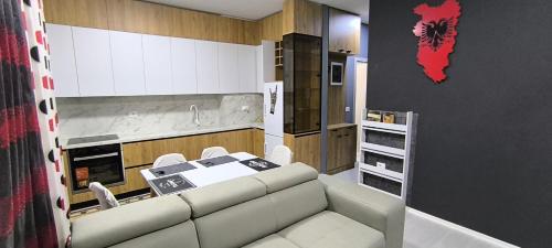 a living room with a couch and a kitchen at Deas Apartments in Tirana in Tirana