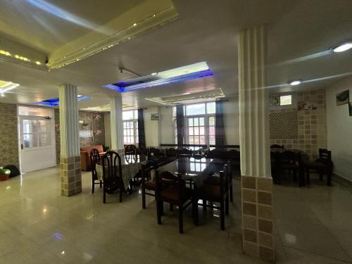 a dining room with a table and chairs at Hotel Redchilli in Dalhousie