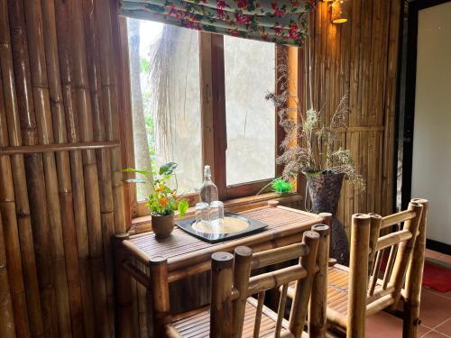 a wooden table in a room with a window at PuBin Spice Hills in Hòa Bình