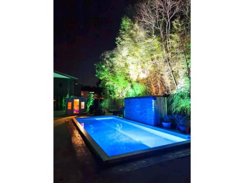 a swimming pool in a backyard at night at Shiseki Ryokan Kagetsu Taishoukan - Vacation STAY 48528v in Takeo