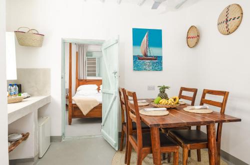 a kitchen and dining room with a table and chairs at Zanzibari holiday home by Liv Zanzibar in Paje