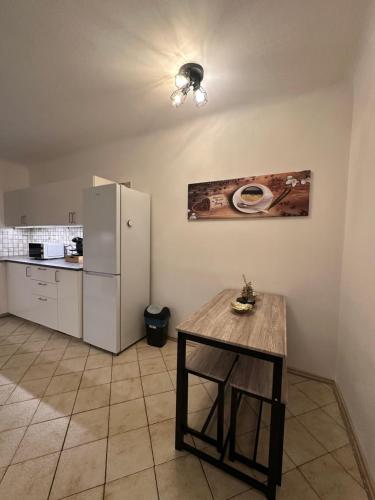 a kitchen with a table and a refrigerator at Cozy 2-Bedroom Retreat Near Subway and City Center in Vienna
