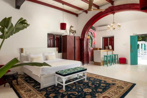 a bedroom with a white bed and a rug at Villa Havana Hues Private Villa in Bentota