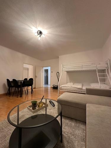 a living room with a bed and a table at Cozy 2-Bedroom Retreat Near Subway and City Center in Vienna
