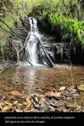 a waterfall in the middle of a river at Cabaña privada en el bosque, cerca al rio Starlinkk in San Mateo Río Hondo