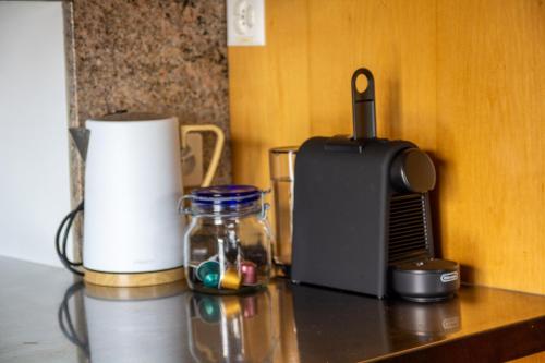 a counter with a toaster and a jar on a table at Haus zum Schiff in Ermatingen