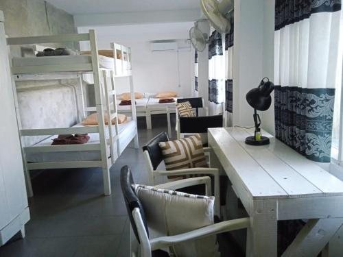 a room with bunk beds and a table and a desk at DEYO MIST in Kandy
