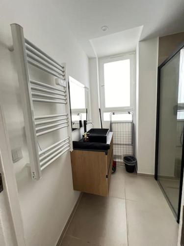 a bathroom with a sink and a window at KB 21 - Metro 7 - AC - Free Parking - 4 pers in Le Kremlin-Bicêtre
