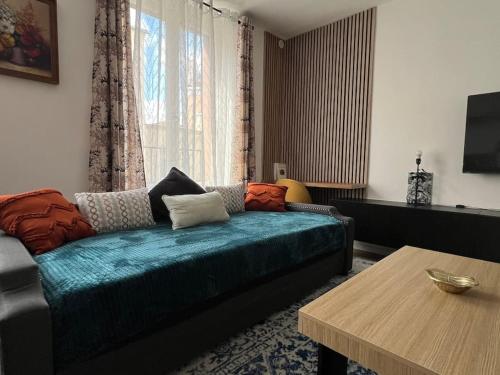 a living room with a couch and a table at KB 21 - Metro 7 - AC - Free Parking - 4 pers in Le Kremlin-Bicêtre