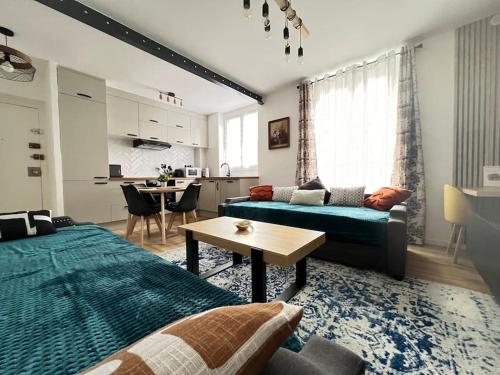 a living room with a couch and a table at KB 21 - Metro 7 - AC - Free Parking - 4 pers in Le Kremlin-Bicêtre