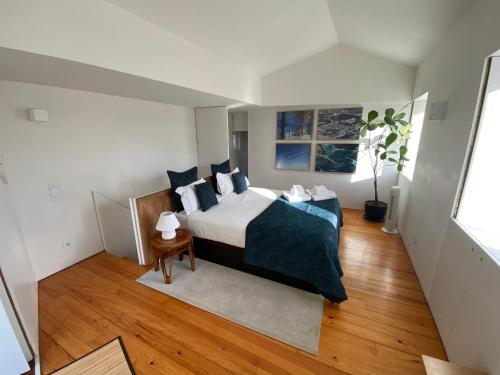 a bedroom with a bed with blue pillows at Casa Dona Olga River View in Porto