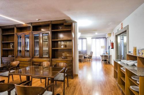 a dining room with a table and some chairs at Hotel Alda Castelao in Vilagarcia de Arousa