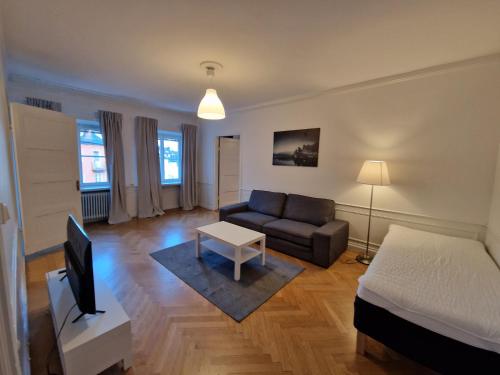 a living room with a bed and a couch at Home Inn Rör11 in Stockholm