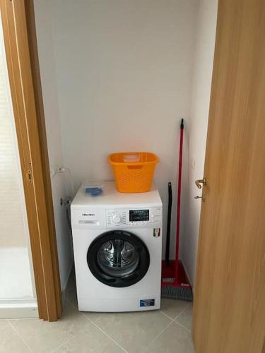 a washing machine with a basket on top of it at Affittacamere Da Maria 3 in Albiano