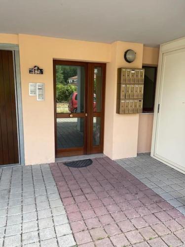 a house with a door and a tiled floor at Affittacamere Da Maria 3 in Albiano