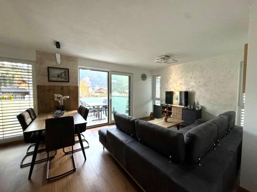 a living room with a couch and a table at Alpin Apartments in Radstadt